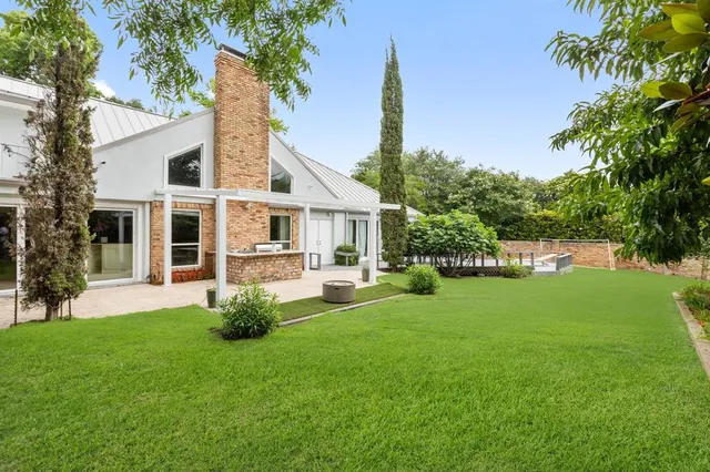 a front view of a house with a garden and yard