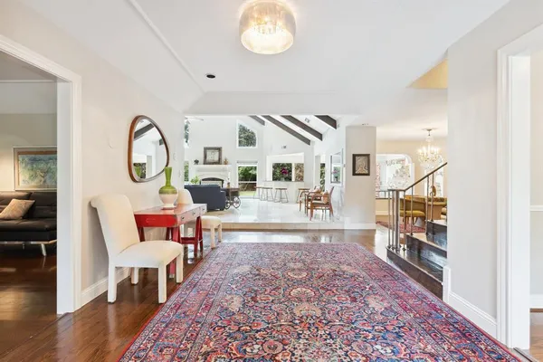 a living room with furniture a rug and a chandelier