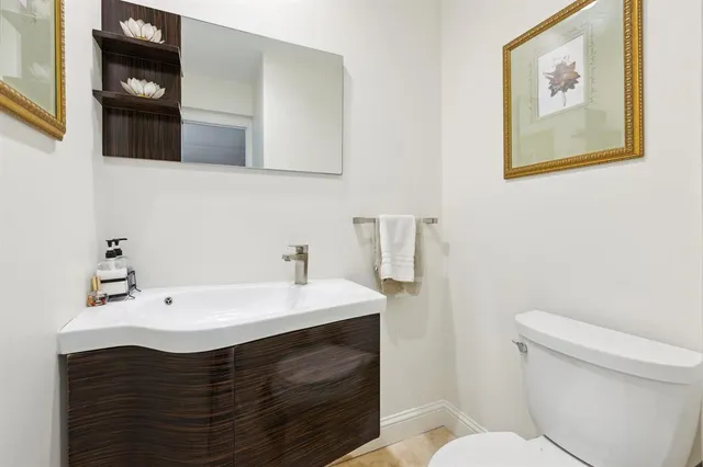 a bathroom with a sink a toilet and mirror