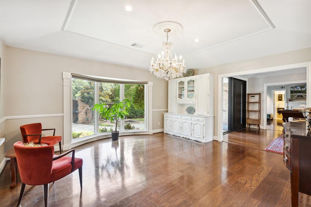 6160 Spring Valley Road Dallas, TX 75240 - Photo 9 of 40 a living room with furniture and a chandelier