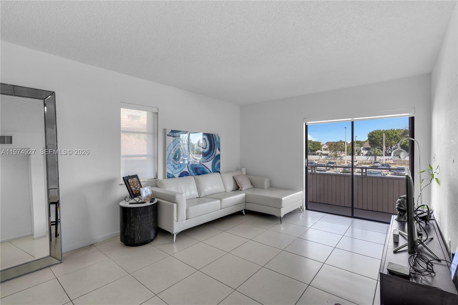 17530 Northwest 68th Avenue, Unit C2003 Hialeah, FL 33015 - Photo 11 of 20 a living room with furniture and a rug