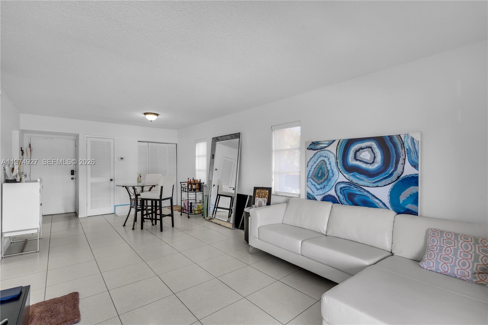 17530 Northwest 68th Avenue, Unit C2003 Hialeah, FL 33015 - Photo 14 of 20 a living room with furniture and a table