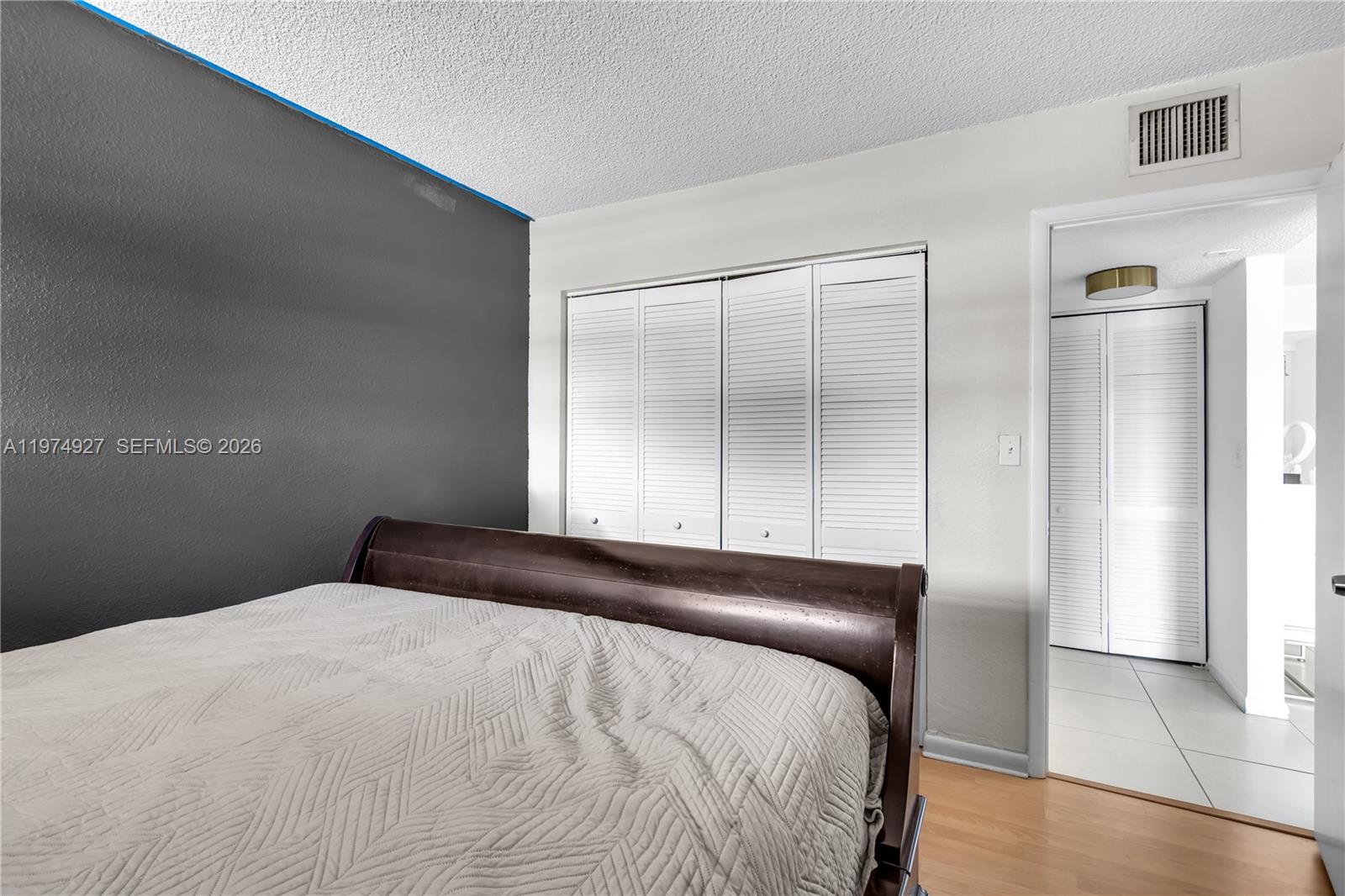 17530 Northwest 68th Avenue, Unit C2003 Hialeah, FL 33015 - Photo 16 of 20 a bedroom with a large bed and a shower