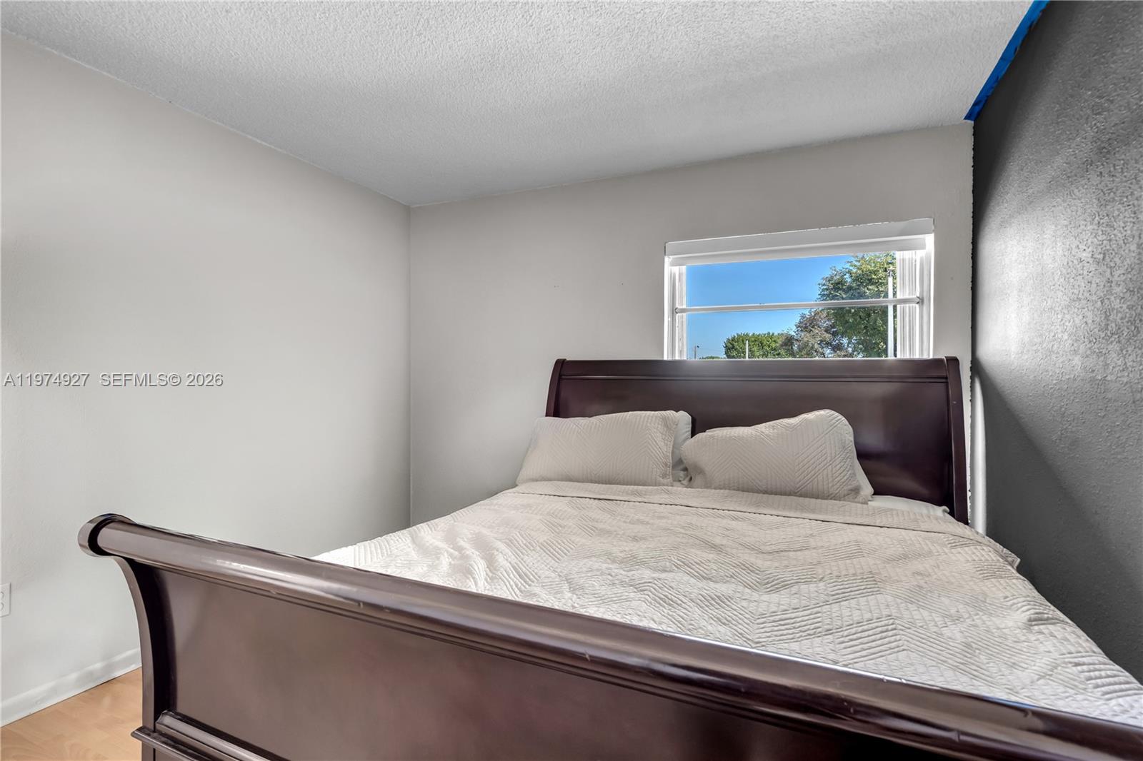 17530 Northwest 68th Avenue, Unit C2003 Hialeah, FL 33015 - Photo 17 of 20 a bedroom with a bed and a window