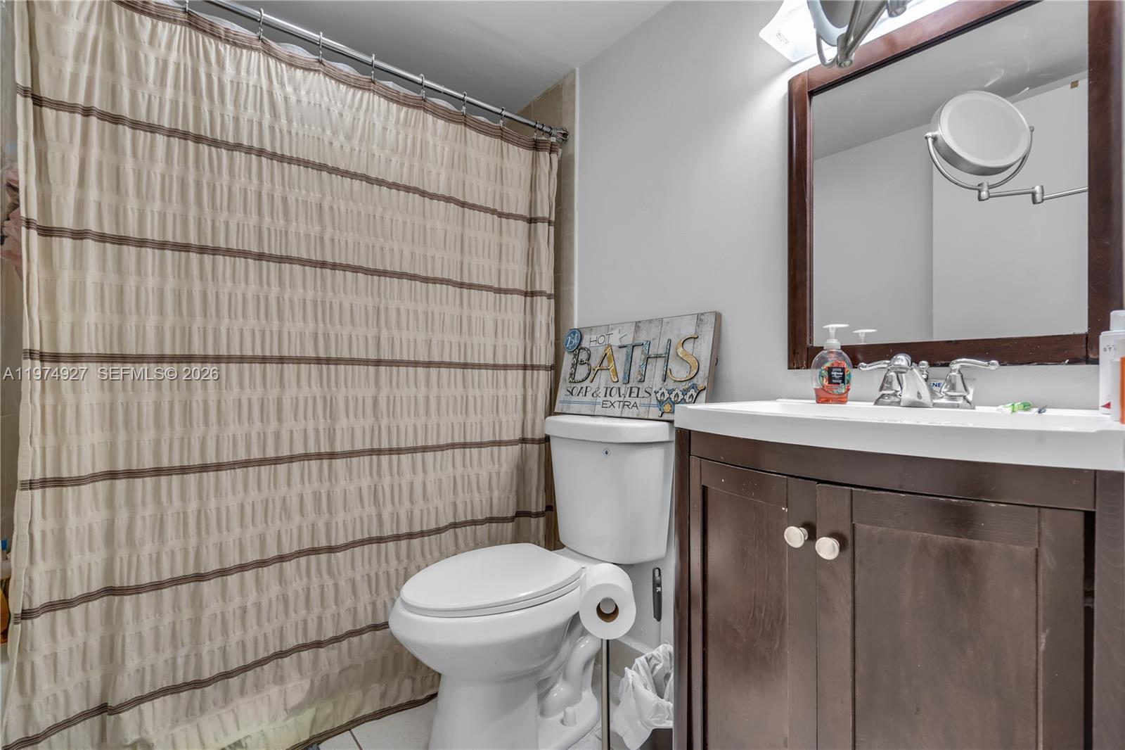 17530 Northwest 68th Avenue, Unit C2003 Hialeah, FL 33015 - Photo 18 of 20 a bathroom with a sink toilet and shower