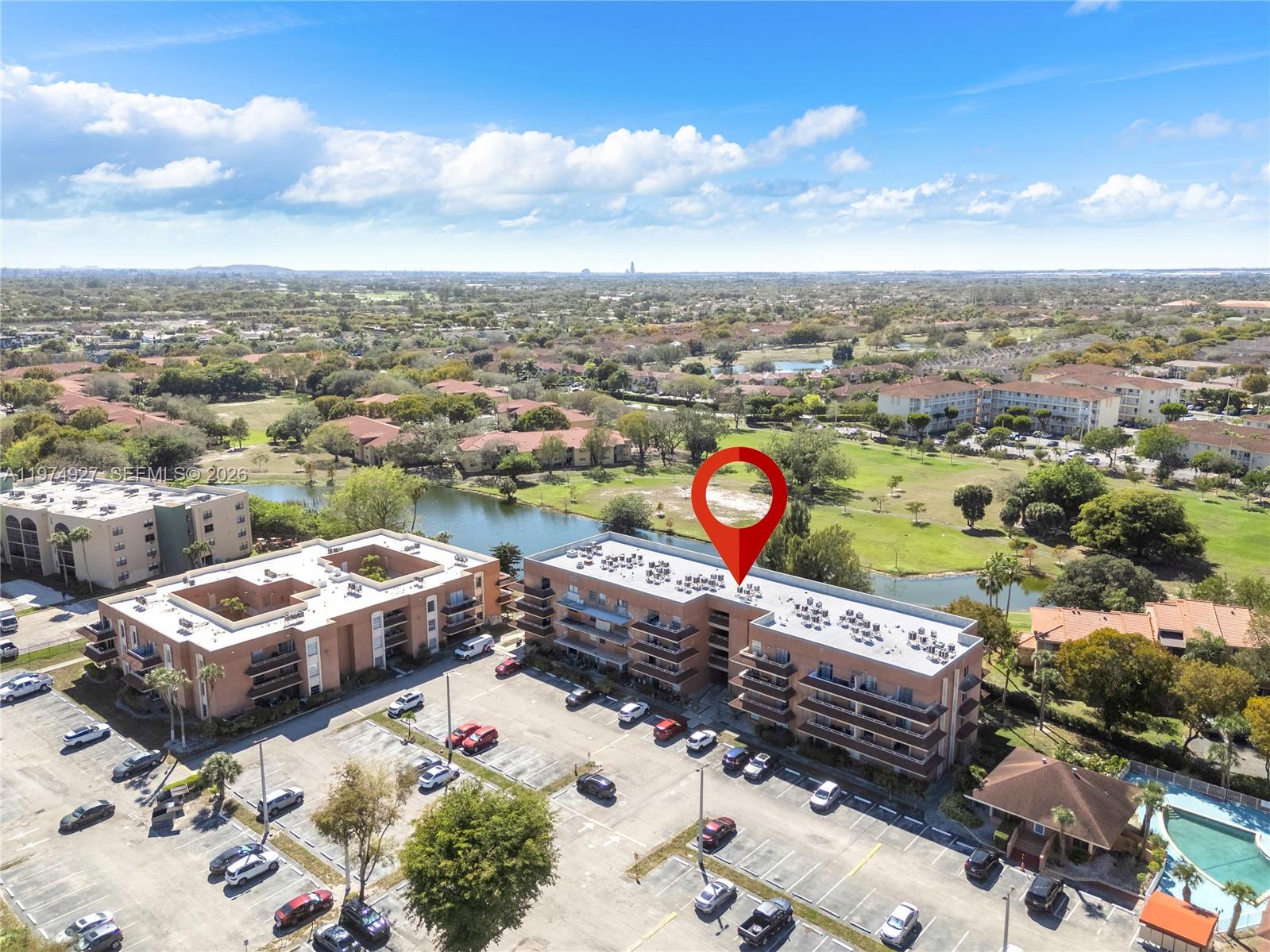 17530 Northwest 68th Avenue, Unit C2003 Hialeah, FL 33015 - Photo 2 of 20 an aerial view of a city with lots of residential buildings
