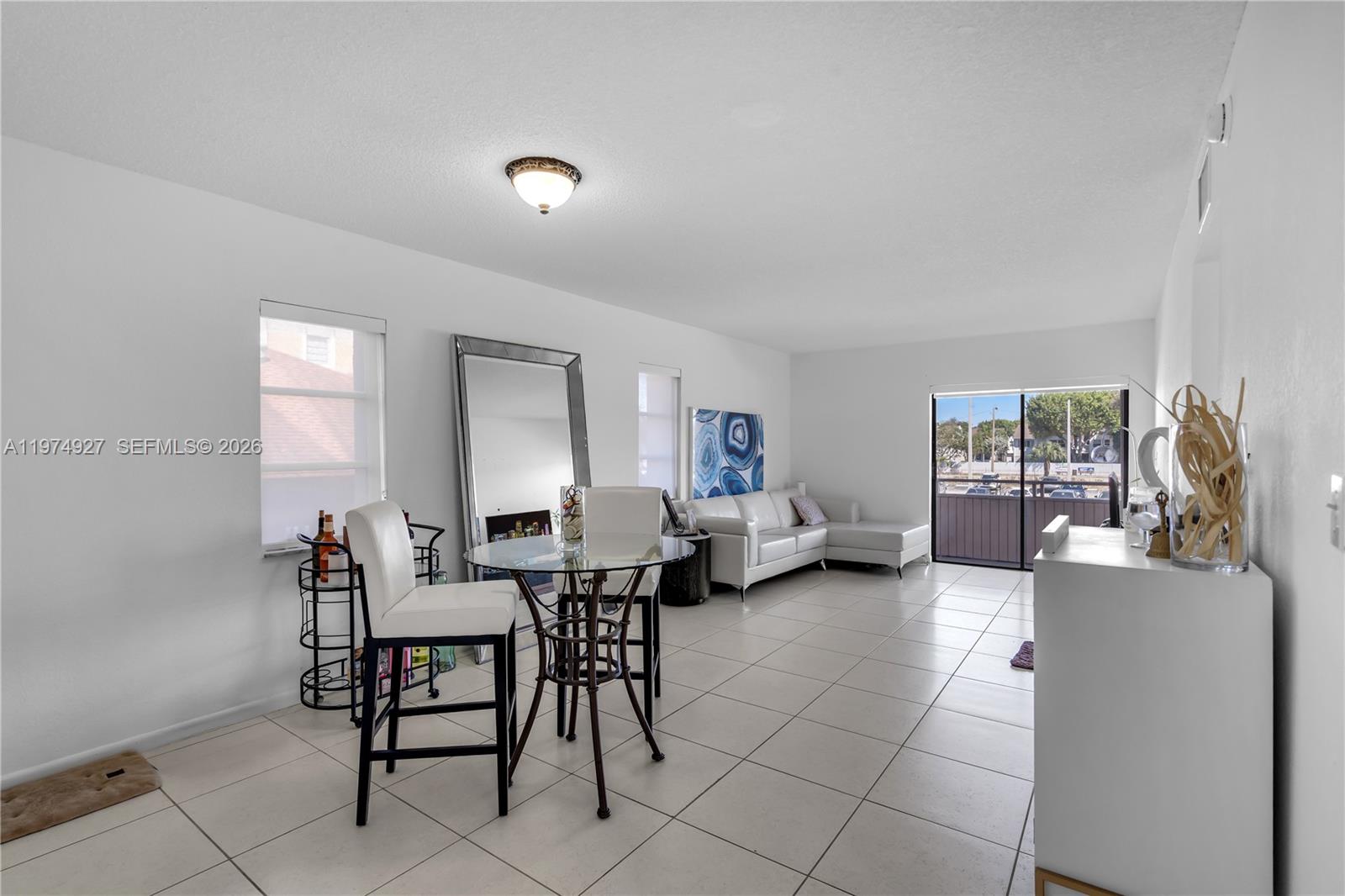 17530 Northwest 68th Avenue, Unit C2003 Hialeah, FL 33015 - Photo 9 of 20 a view of a livingroom with furniture and lounge chair