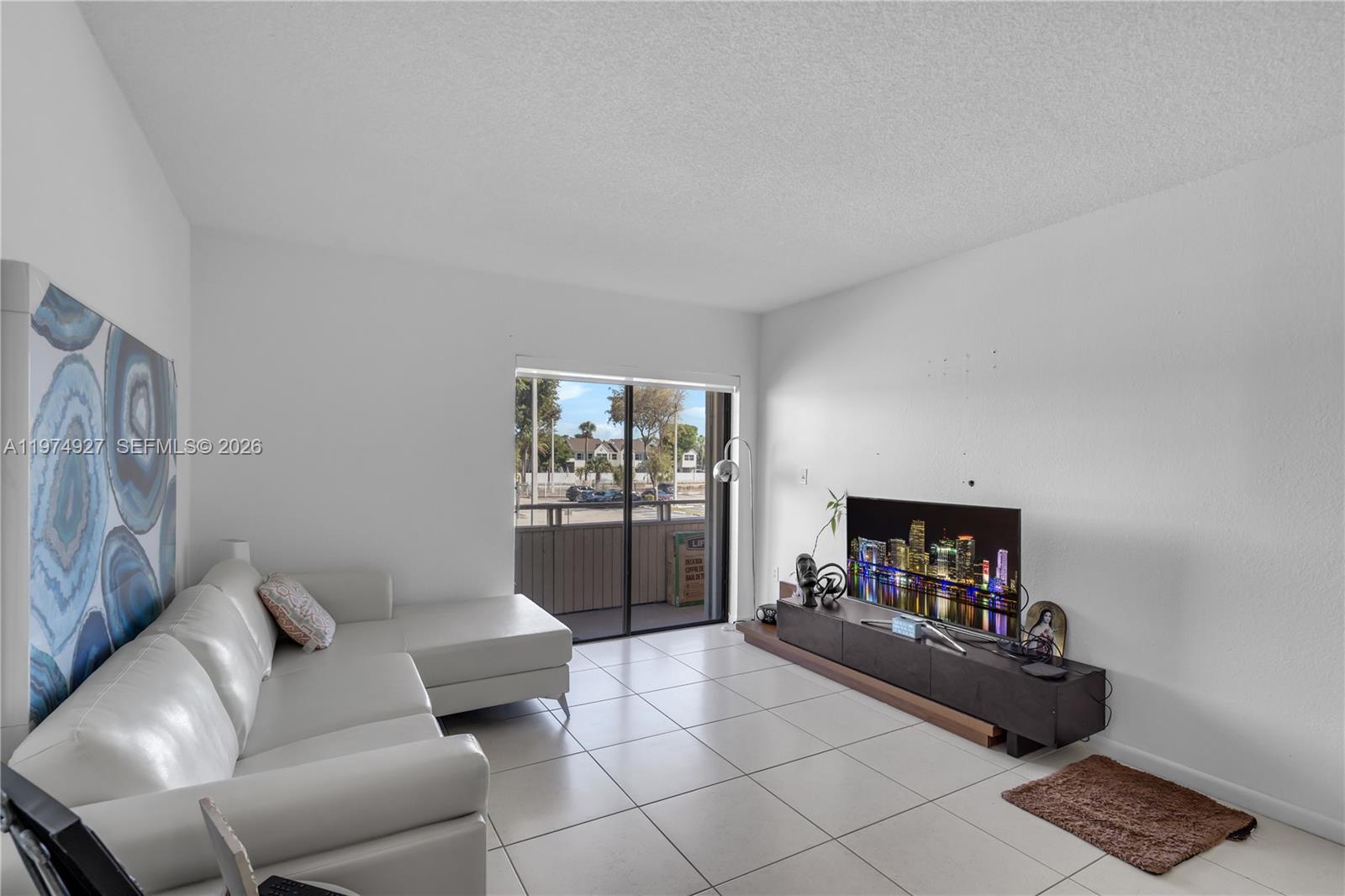 17530 Northwest 68th Avenue, Unit C2003 Hialeah, FL 33015 - Photo 10 of 20 a room with furniture and a couch