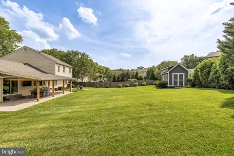 a front view of house with yard and trees