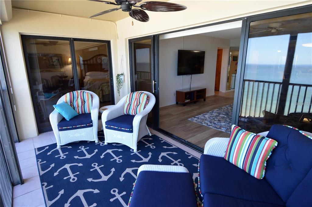 900 Gulf Boulevard, Unit 907 Indian Rocks Beach, FL 33785 - Photo 23 of 88 a living room with furniture and a flat screen tv