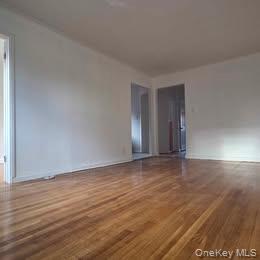 38-21 149th Place Queens, NY 11354 - Photo 2 of 11 a view of an empty room with wooden floor