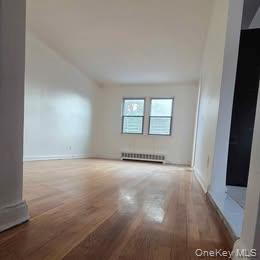 38-21 149th Place Queens, NY 11354 - Photo 4 of 11 an empty room with windows and entrance