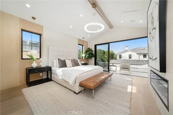 a spacious bedroom with a large bed and a large window