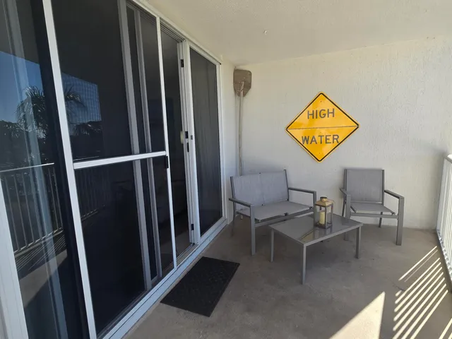 a view of a hallway with furniture and a entryway