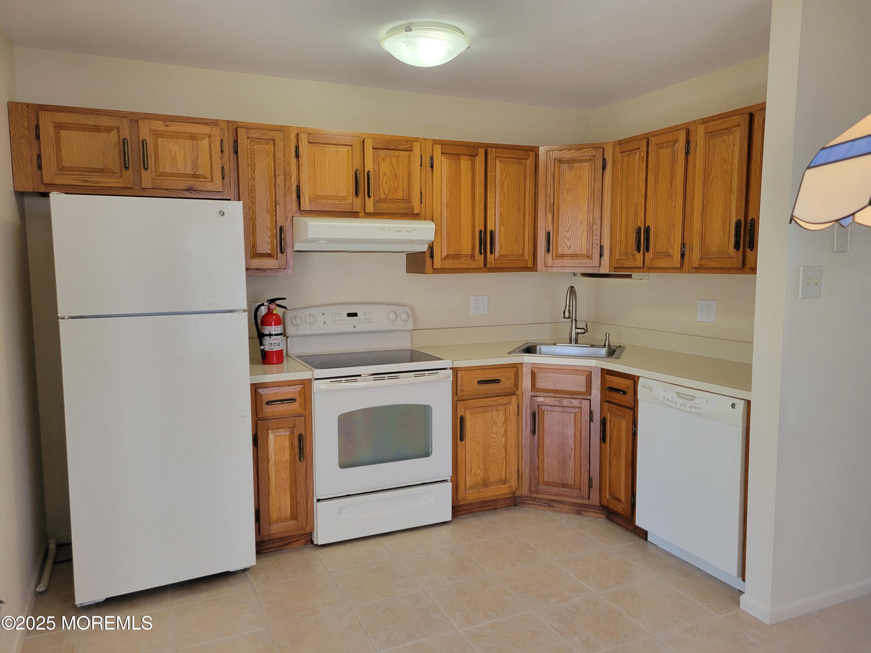 239 Valley Forge Drive Little Egg Harbor, NJ 08087 - Photo 11 of 24 a kitchen with a refrigerator sink stove and cabinets