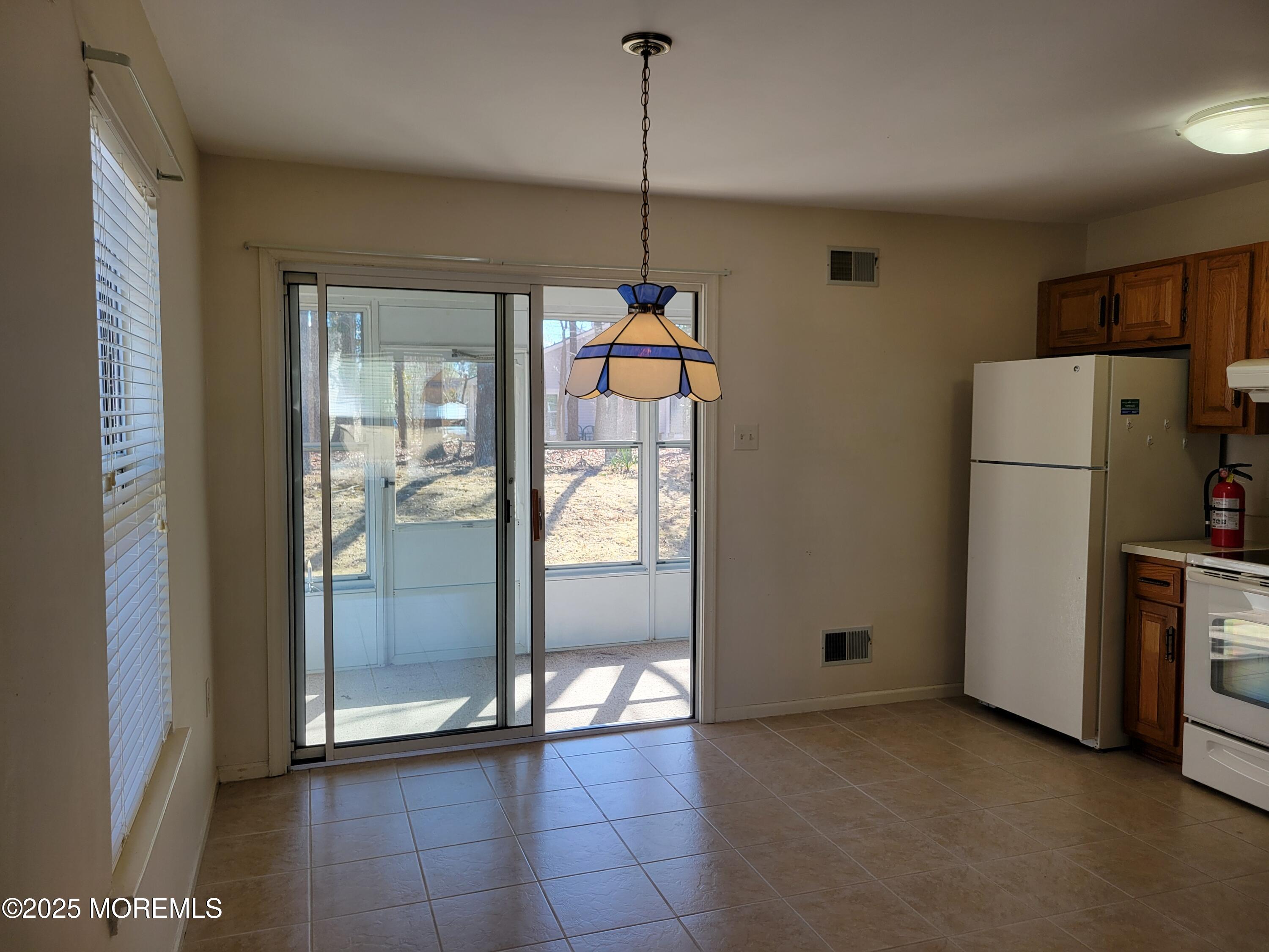 239 Valley Forge Drive Little Egg Harbor, NJ 08087 - Photo 9 of 24 a view of a storage & utility room with refrigerator and window