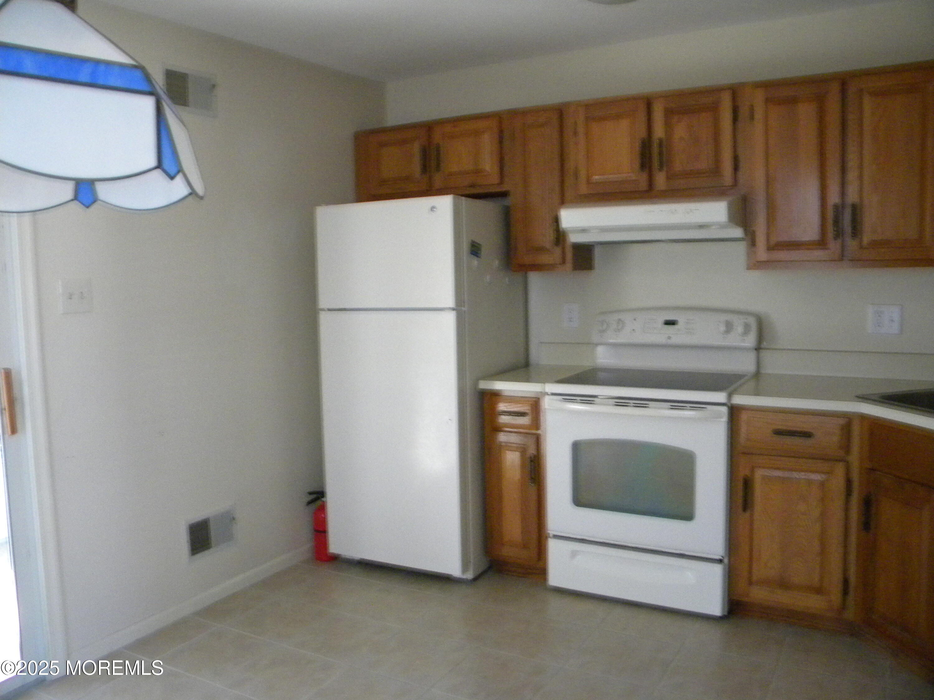 239 Valley Forge Drive Little Egg Harbor, NJ 08087 - Photo 10 of 24 a kitchen with a stove and a refrigerator