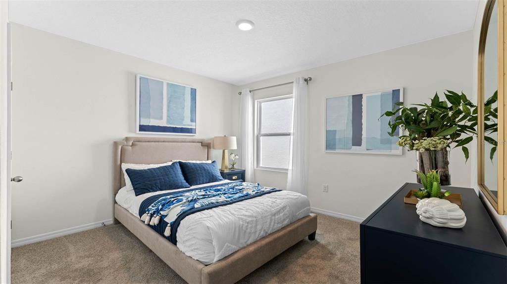 2131 Red Rock Road New Smyrna Beach, FL 32168 - Photo 14 of 20 a bedroom with a bed and a table