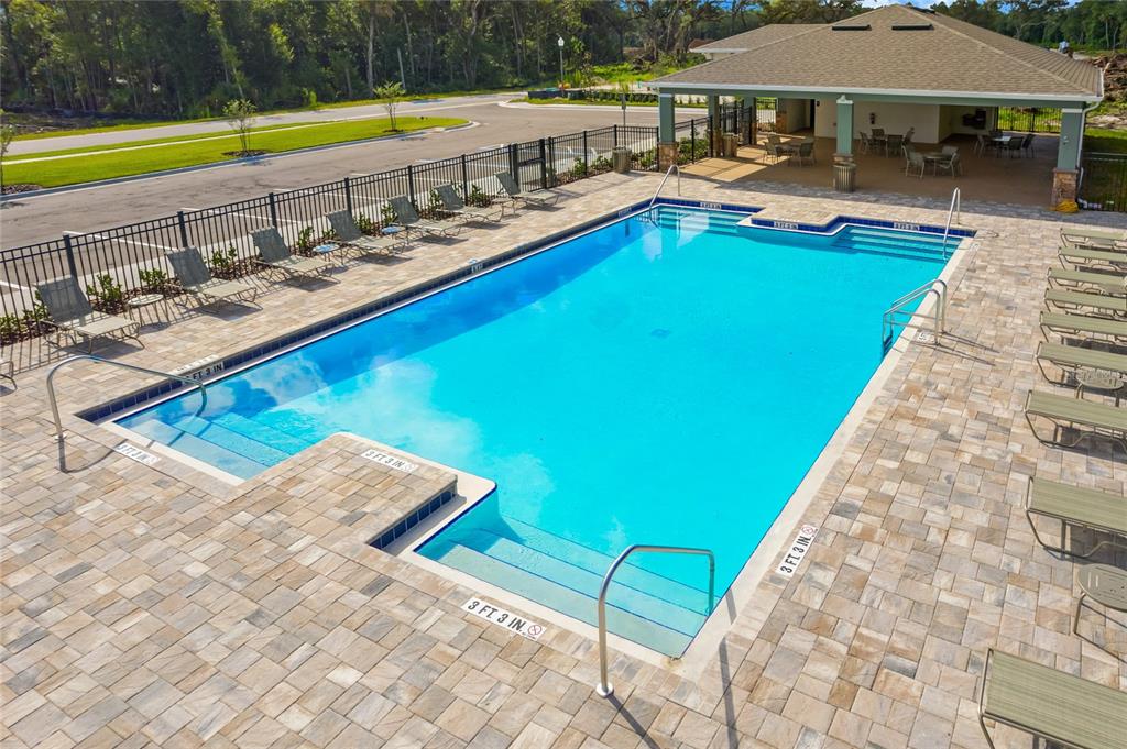2131 Red Rock Road New Smyrna Beach, FL 32168 - Photo 18 of 20 a view of a swimming pool and lounge chairs