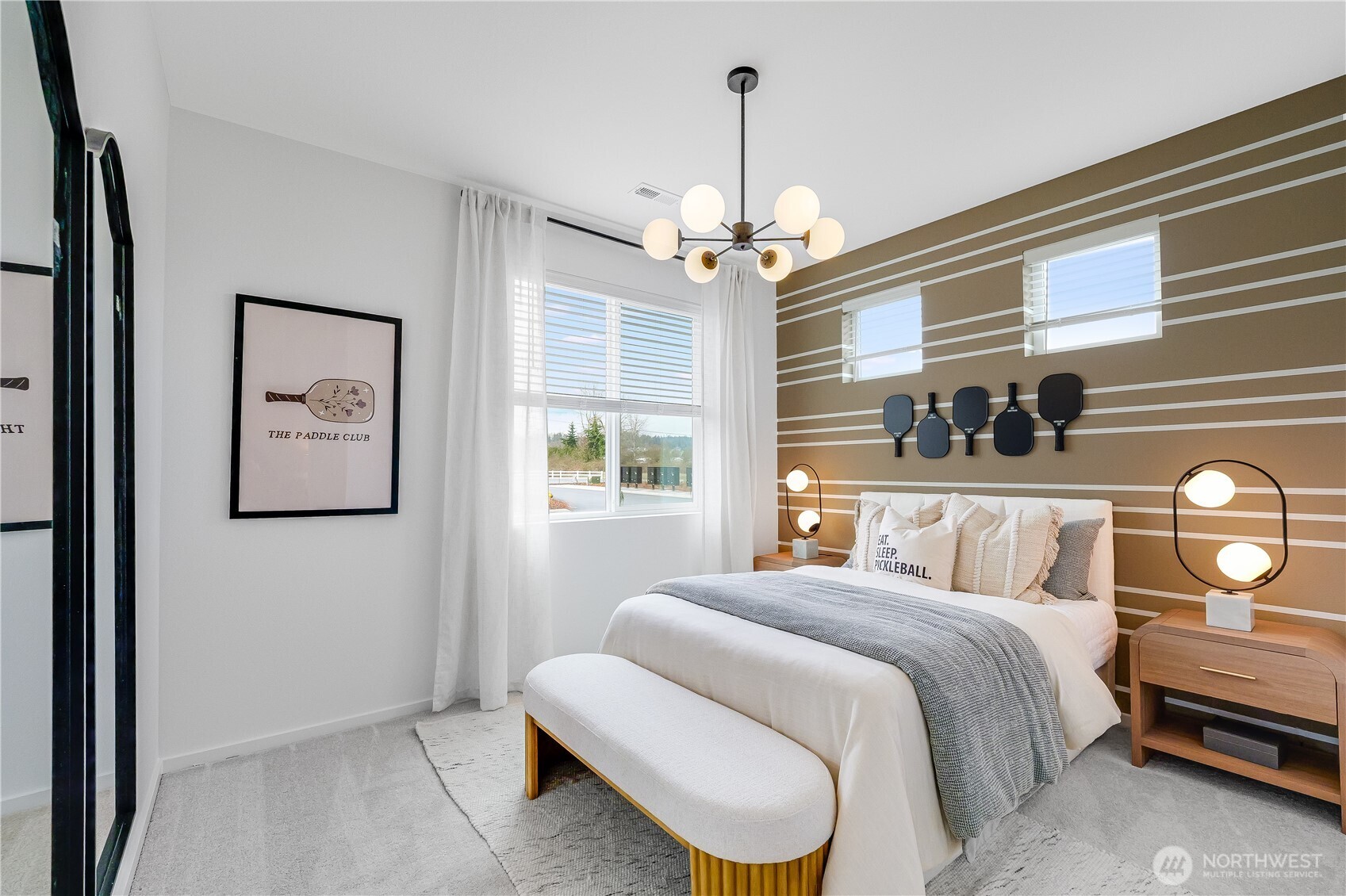 132 Moonshadow Lane Sequim, WA 98382 - Photo 23 of 28 a bedroom with a bed and a chandelier
