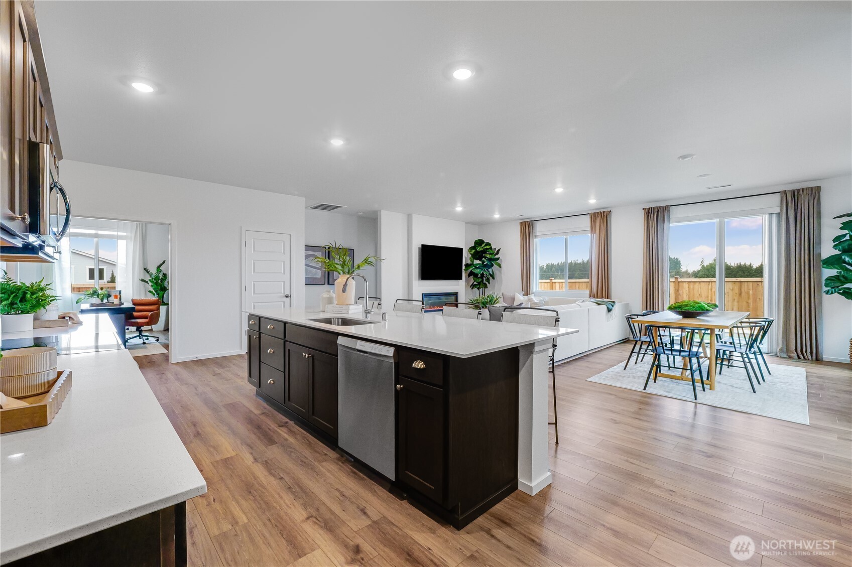 132 Moonshadow Lane Sequim, WA 98382 - Photo 5 of 28 a kitchen with stainless steel appliances granite countertop a table chairs and a refrigerator