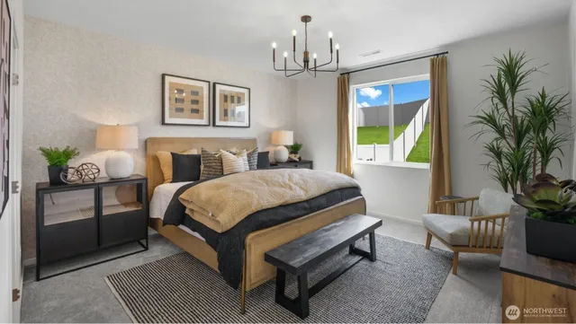 a spacious bedroom with a bed a couch and a potted plant