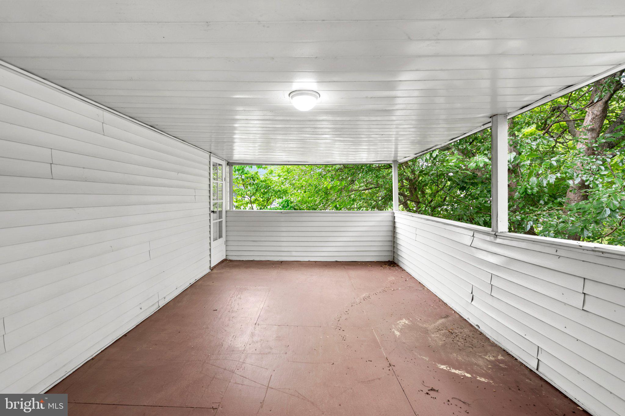 609 Foster Road Cheltenham, PA 19012 - Photo 40 of 44 Serene enclosed porch with nature views.