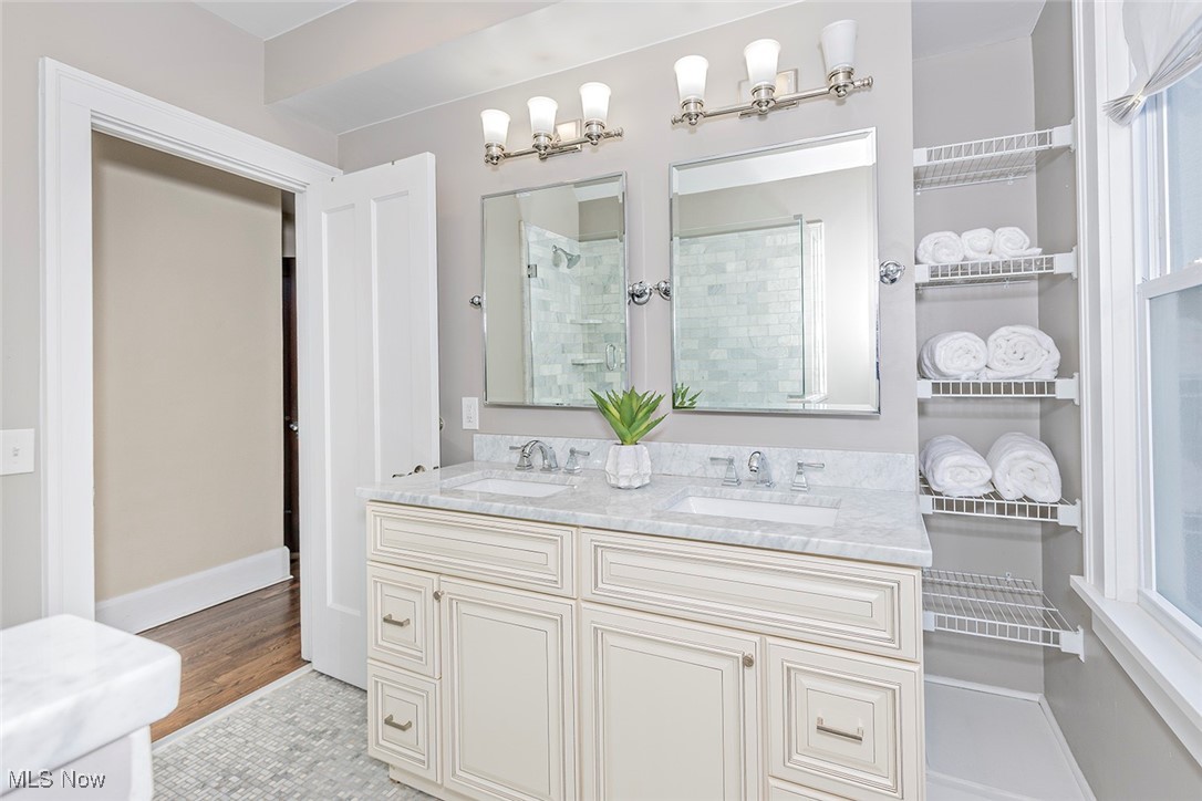 2875 Coleridge Road Cleveland, OH 44118 - Photo 16 of 37 Bathroom featuring double vanity, a shower stall, and light wood-type flooring