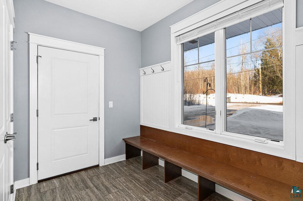 3879 Okerstrom Road Hermantown, MN 55811 - Photo 30 of 32 Mudroom featuring dark wood-type flooring and baseboards