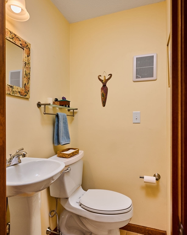72 Reservation Road Sunderland, MA 01375 - Photo 13 of 38 a bathroom with a sink a toilet and mirror