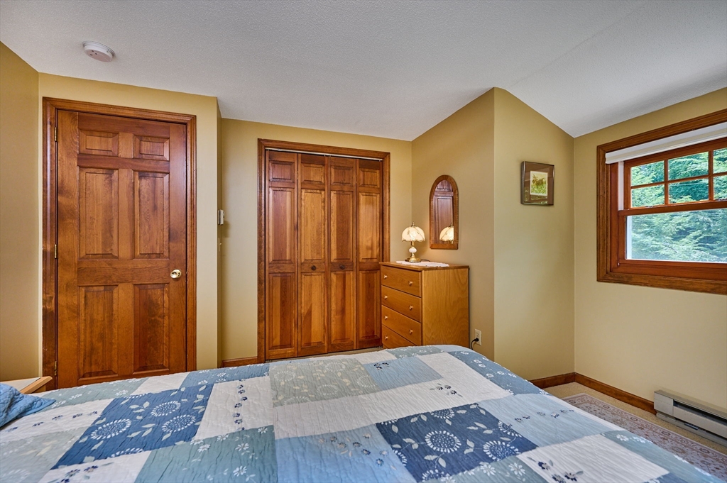72 Reservation Road Sunderland, MA 01375 - Photo 17 of 38 a bedroom with a bed and wooden floor