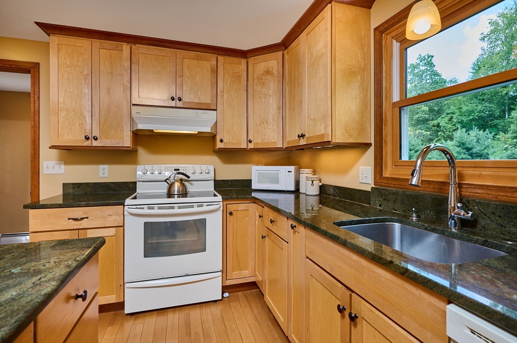 72 Reservation Road Sunderland, MA 01375 - Photo 5 of 38 a kitchen with granite countertop a sink a stove and cabinets