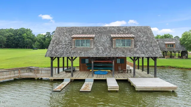 an aerial view of a house with pool lake view and mountain view