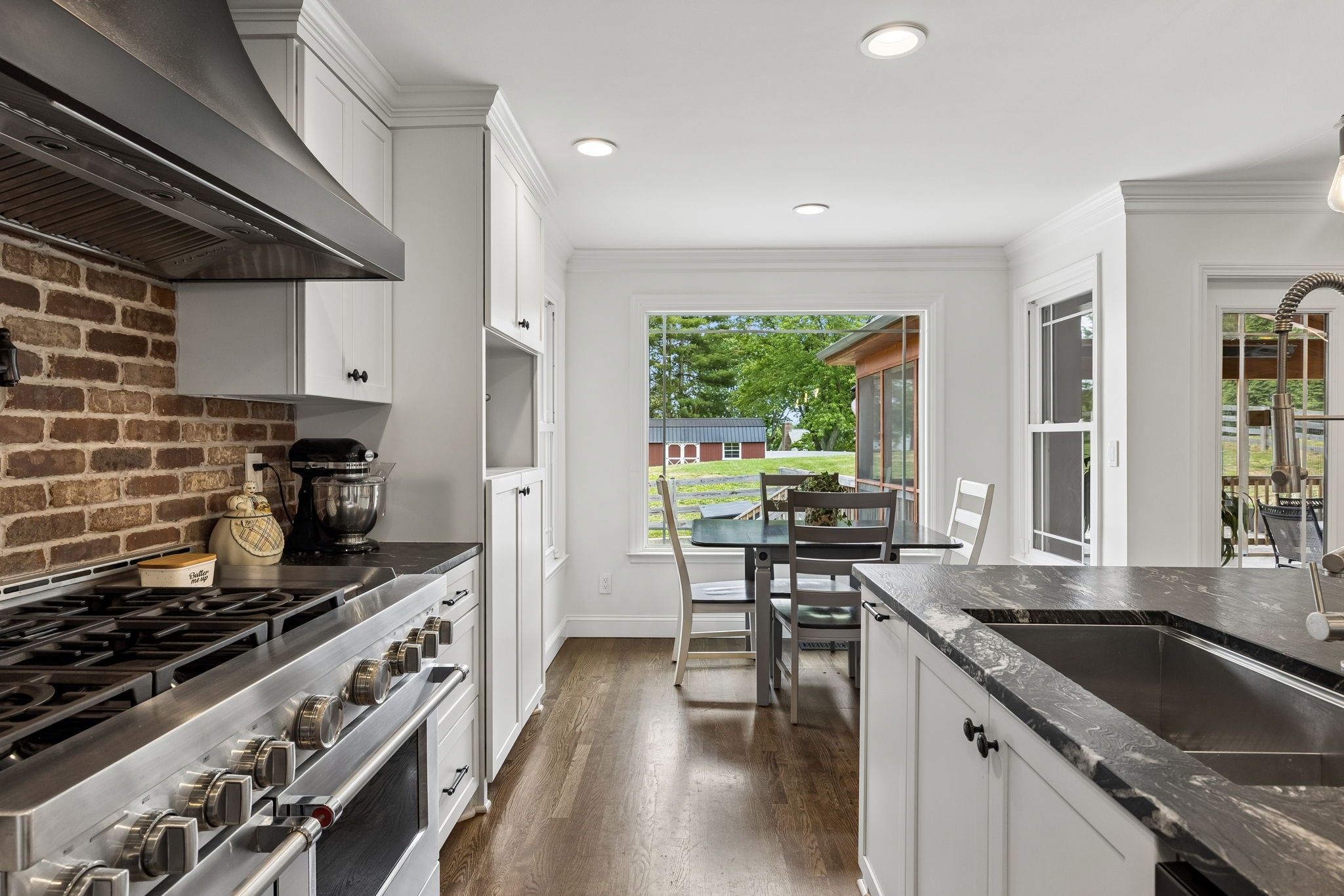 102 Azalea Lane Franklin, TN 37064 - Photo 5 of 41 a kitchen with stainless steel appliances granite countertop a stove a sink and a microwave