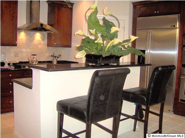 2201 River Road, Unit 3204 Point Pleasant, NJ 08742 - Photo 3 of 3 a kitchen with stainless steel appliances granite countertop white cabinets a stove top oven a sink and dishwasher