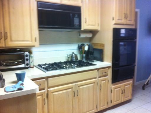620 Geronimo Street Hoffman Estates, IL 60169 - Photo 3 of 8 a kitchen with granite countertop a stove and a microwave
