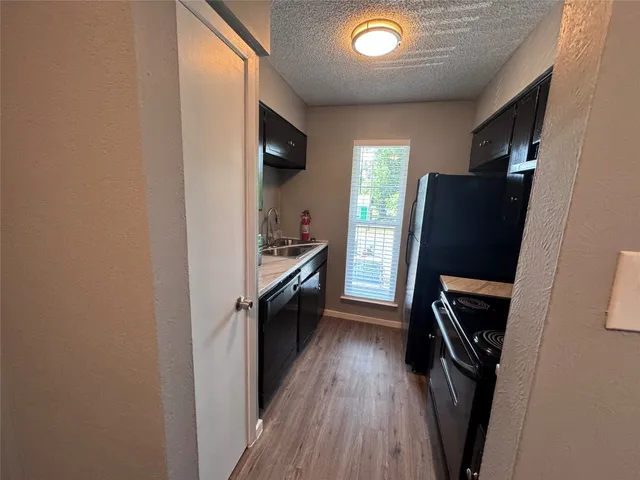 a view of kitchen and refrigerator