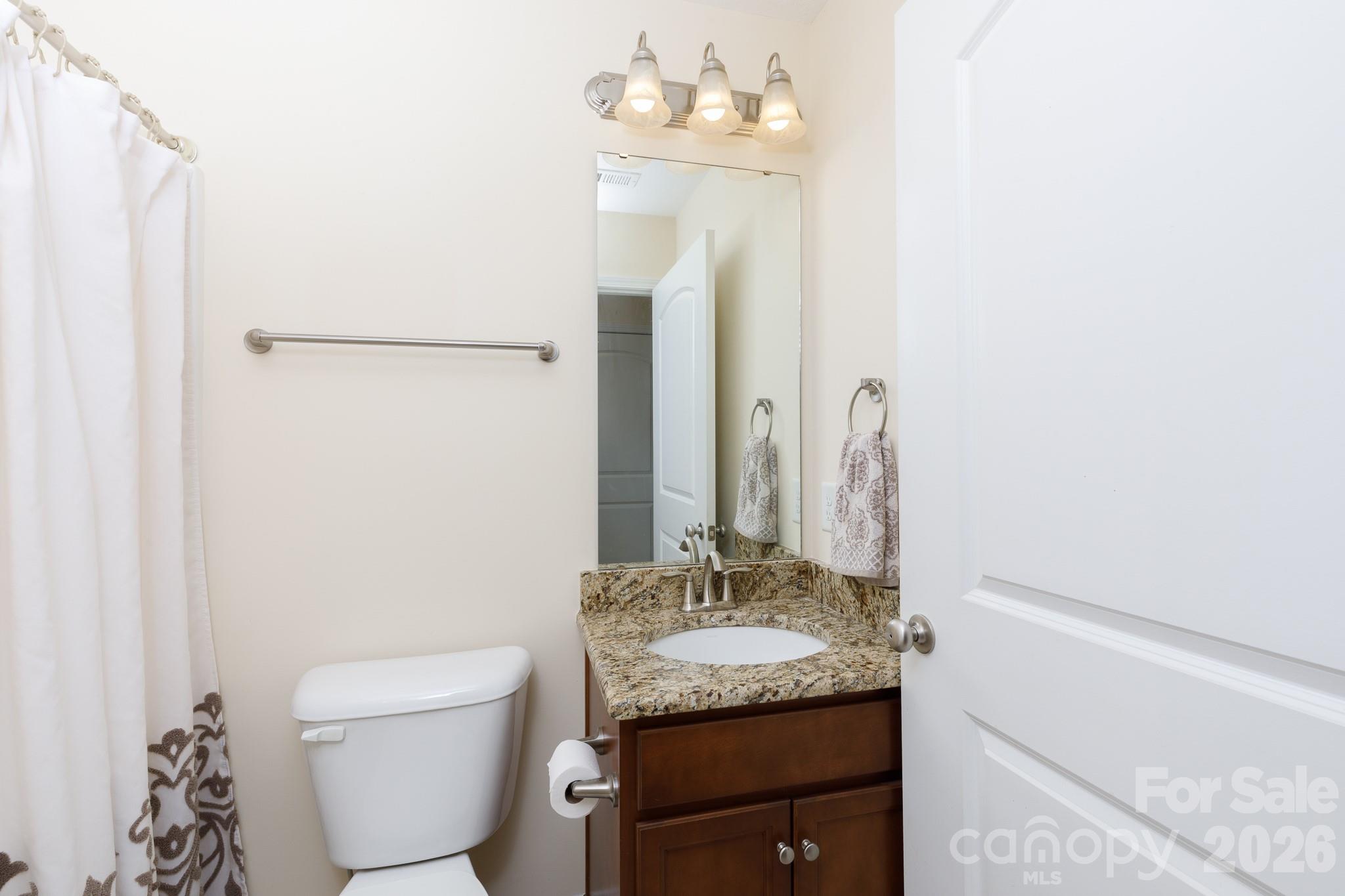 3692 Armstrong Ford Road Rock Hill, SC 29730 - Photo 22 of 30 a bathroom with a granite countertop sink and a mirror