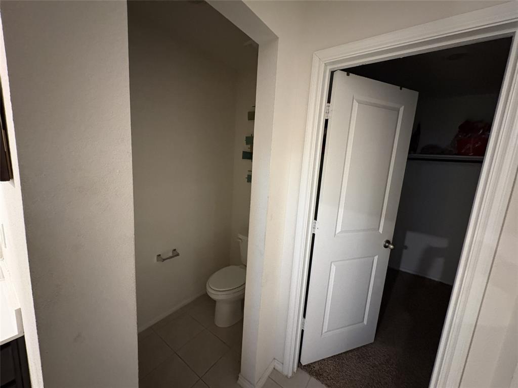 3124 Patton Lane Forney, TX 75126 - Photo 5 of 19 a bathroom with a toilet and a mirror