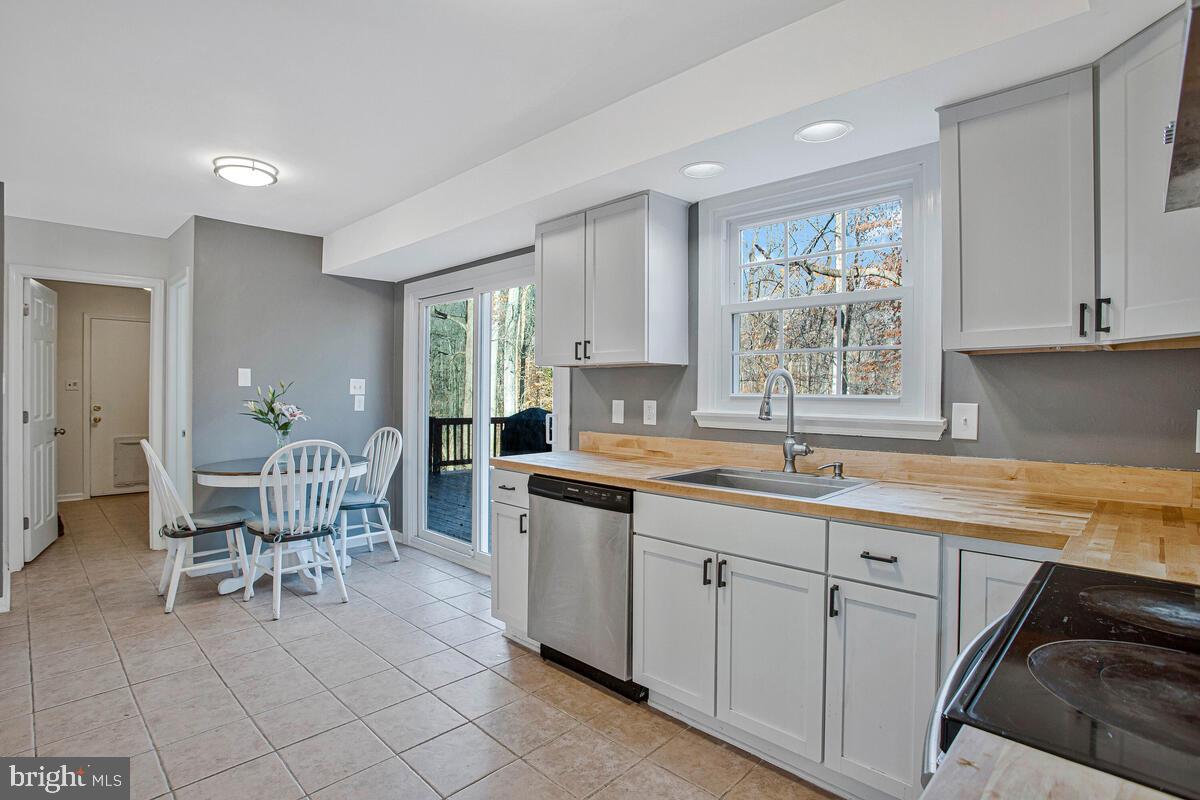 9230 Sam Owing's Place Owings, MD 20736 - Photo 16 of 44 a kitchen with a sink table and chairs