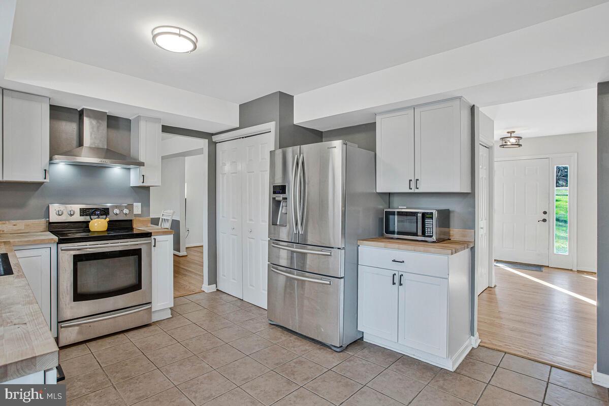 9230 Sam Owing's Place Owings, MD 20736 - Photo 19 of 44 a kitchen with white cabinets and stainless steel appliances