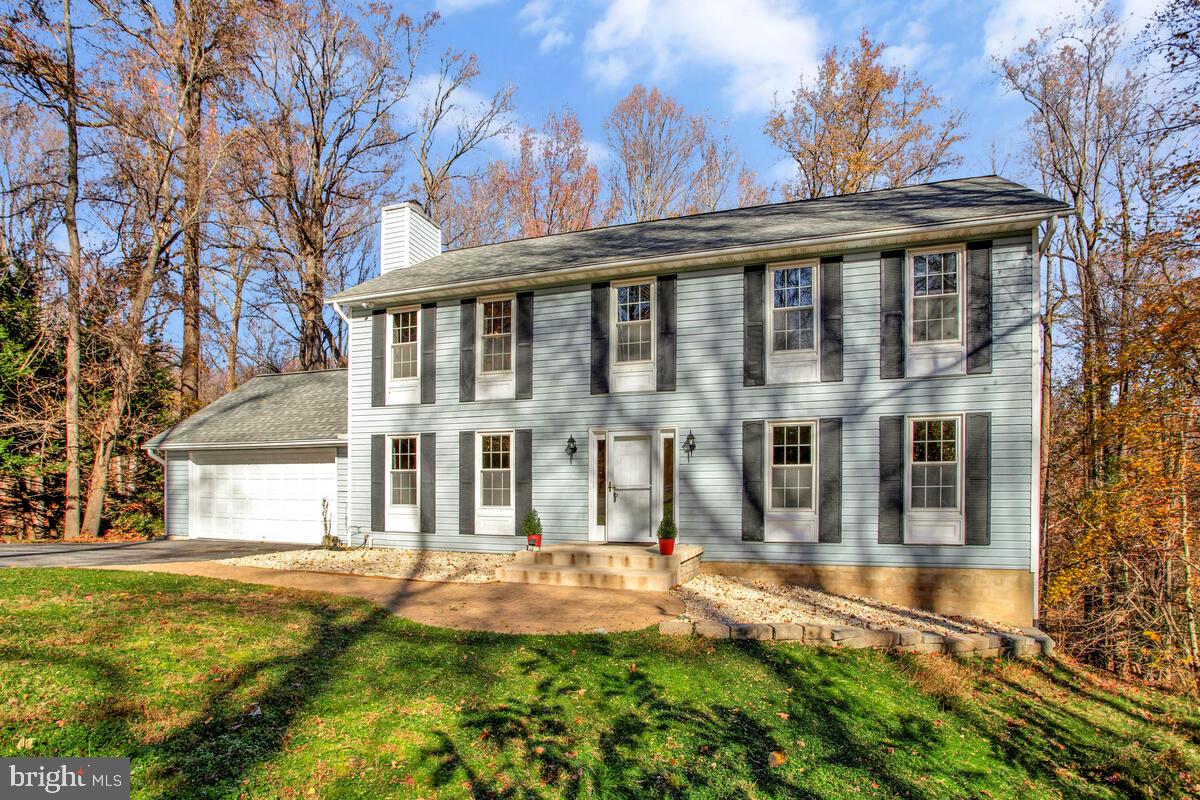 9230 Sam Owing's Place Owings, MD 20736 - Photo 2 of 44 a front view of a house with a yard