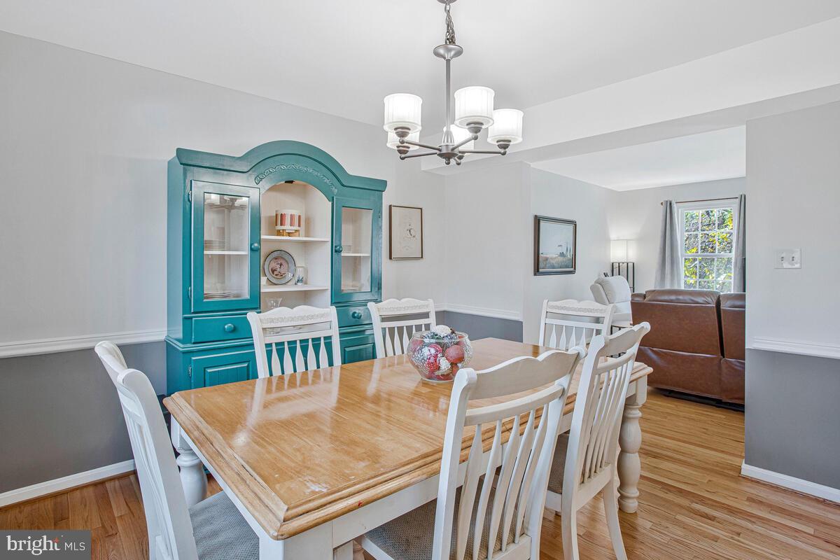 9230 Sam Owing's Place Owings, MD 20736 - Photo 22 of 44 a view of a dining room with furniture a chandelier and wooden floor