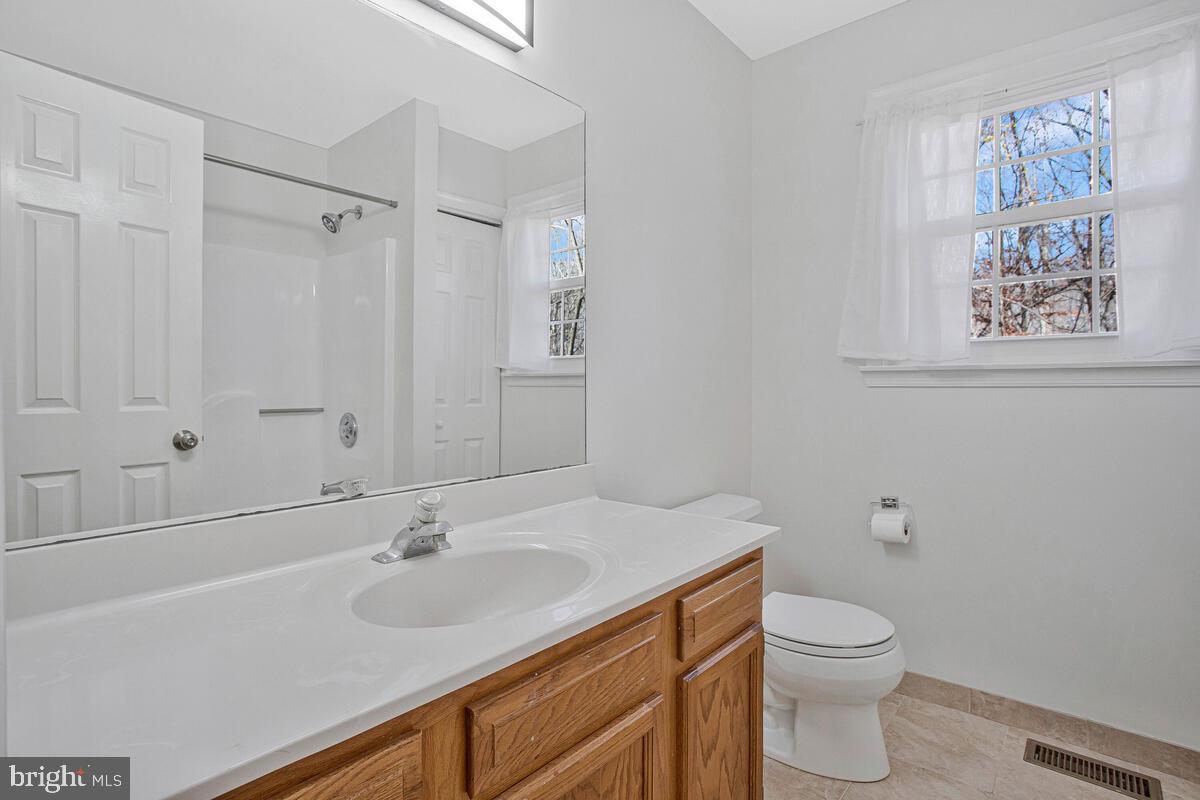 9230 Sam Owing's Place Owings, MD 20736 - Photo 25 of 44 a bathroom with a toilet sink and mirror