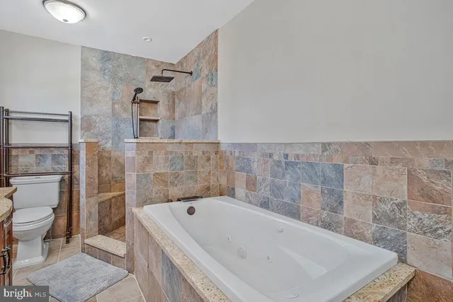 a bathroom with a bathtub and toilet