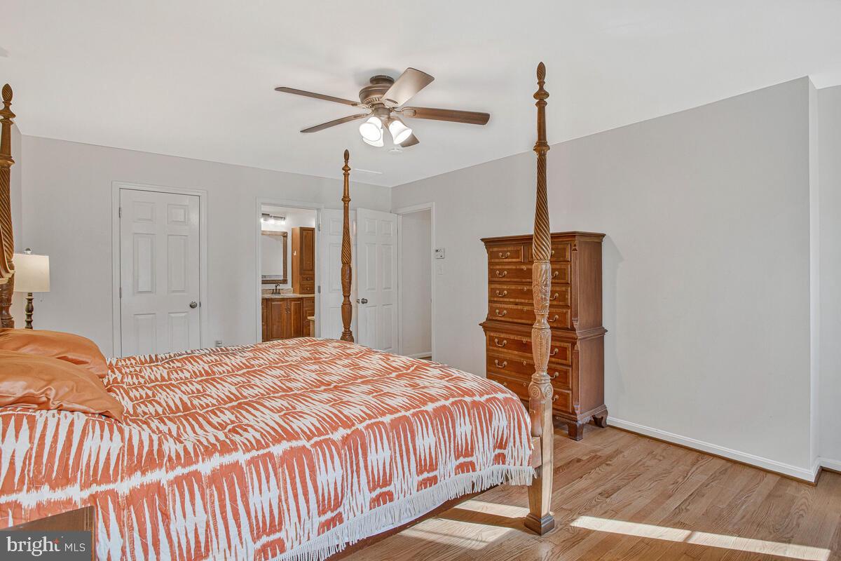 9230 Sam Owing's Place Owings, MD 20736 - Photo 32 of 44 a bedroom with a bed and a chandelier