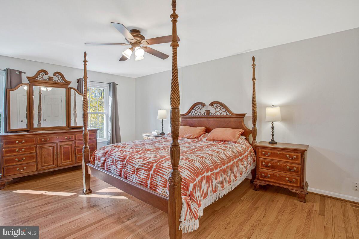 9230 Sam Owing's Place Owings, MD 20736 - Photo 33 of 44 a bedroom with a bed a chandelier and dresser