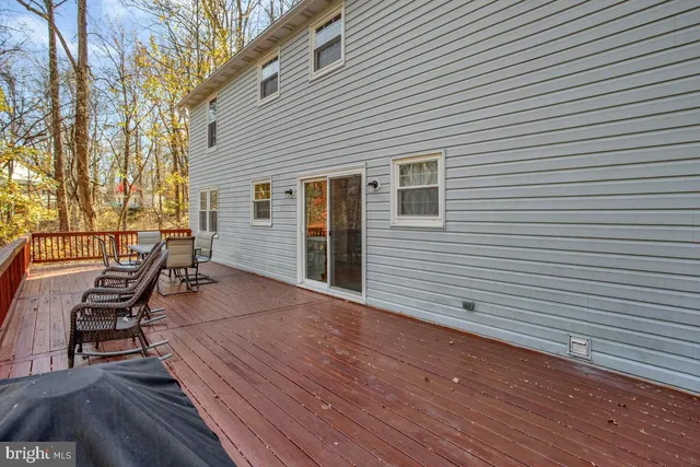 a roof deck with table and chairs and wooden floor