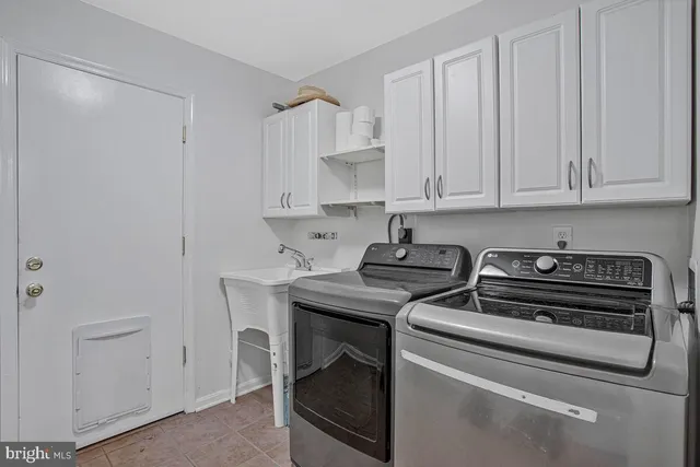 a view of a storage and utility room with washer and dryer
