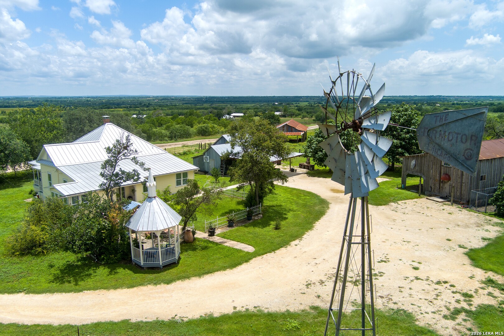 a view of a house with a yard and sitting area